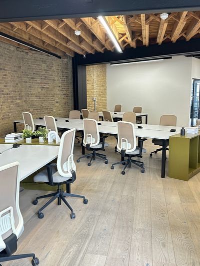 Modern office space with ergonomic chairs and wooden ceiling.