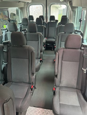 Interior view of a passenger van with multiple rows of seats.