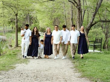 Family walking together on a wooded path during spring.
