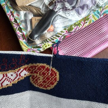 Adding a binding stitch to a bag strap.