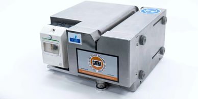 Industrial testing machine with a CATRA label and Schneider Electric component.