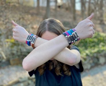 a girl wearing different SnappBandZ in both hands