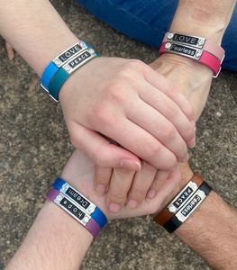 Four Hands Wearing Different Color Bands