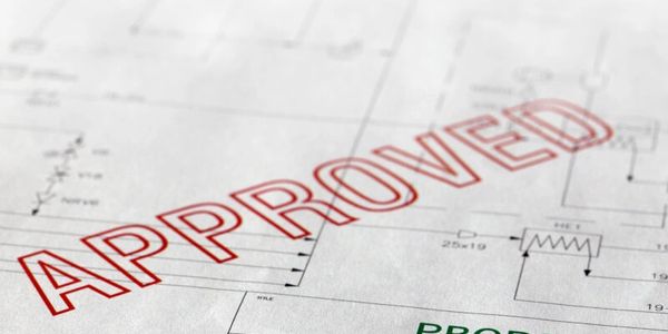 Blueprint marked with a large red "APPROVED" stamp.