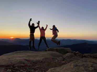 Three people jumping together