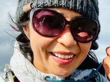 Two hikers with a black dog