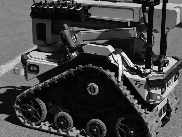 Close-up of a tracked robotic vehicle's tread and control system.