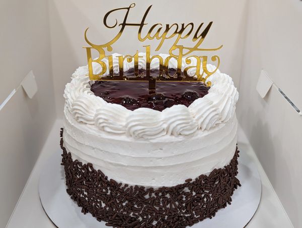 6-inch (3-layer) black forest cake, vanilla textured frosting, shell border, chocolate sprinkles