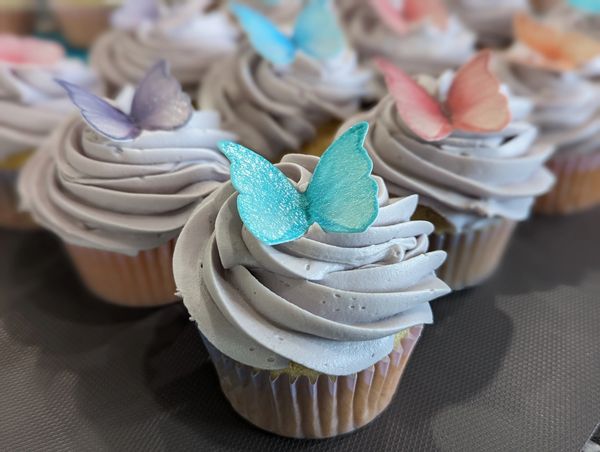 Butterfly cupcakes, vanilla frosting in lavender, edible rice paper butterflies