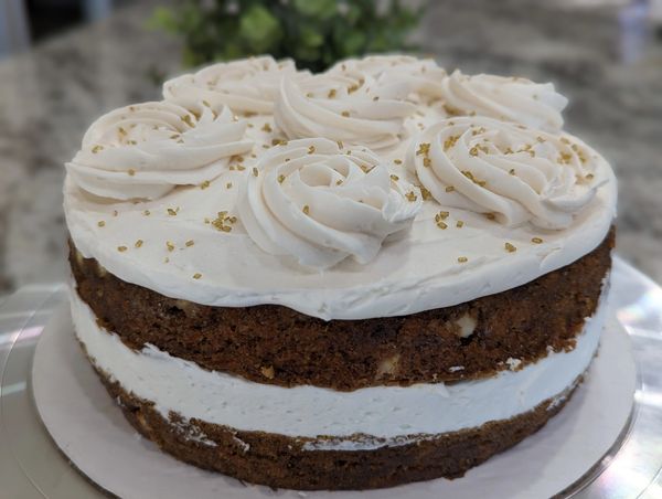 8-inch naked carrot cake (no frosting on sides), large spaced rosettes, gold sprinkles