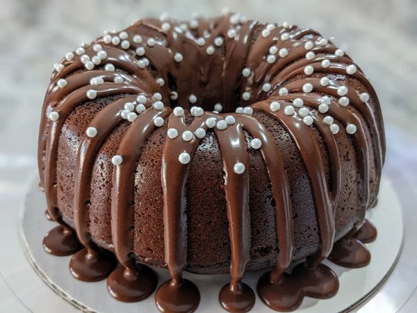 7-inch chocolate bundt cake with thick chocolate glaze, white pearls