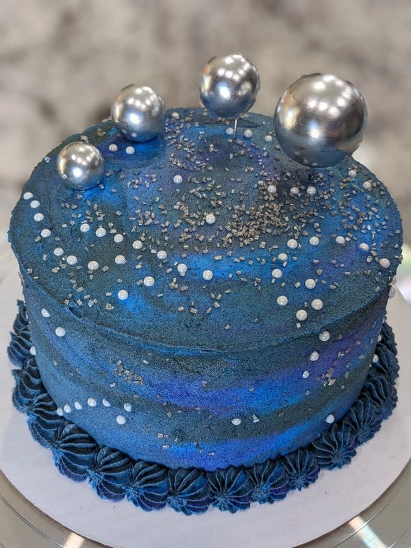 6-inch (3-layer) space cake, vanilla flat marbled frosting, star bottom border, silver sprinkles