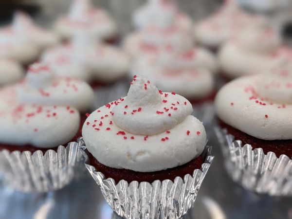 MINI red velvet cupcakes, vanilla frosting, red sprinkles