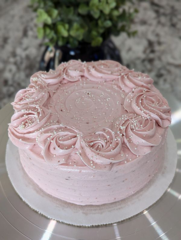 6-inch cake, strawberry frosting, rosette top border, white nonpareils