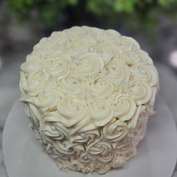 6-inch 3-layer cake, vanilla frosting, tight rosettes covering top and sides, white pearls