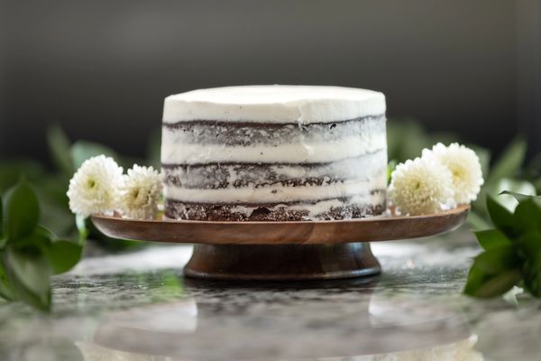 6-inch 3-layer chocolate cake, semi-naked (see through frosting on sides), flat top