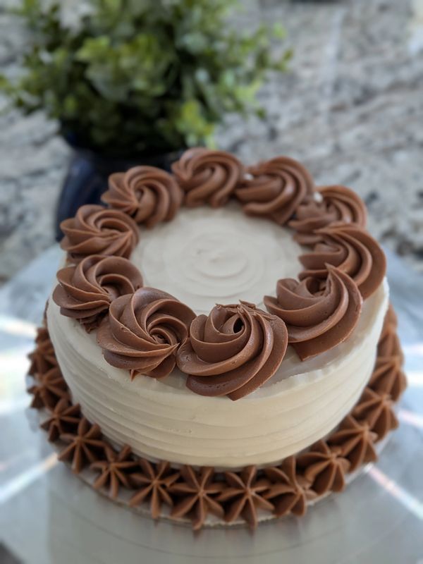 6-inch cake, vanilla textured frosting, chocolate frosting rosette top border and star bottom border