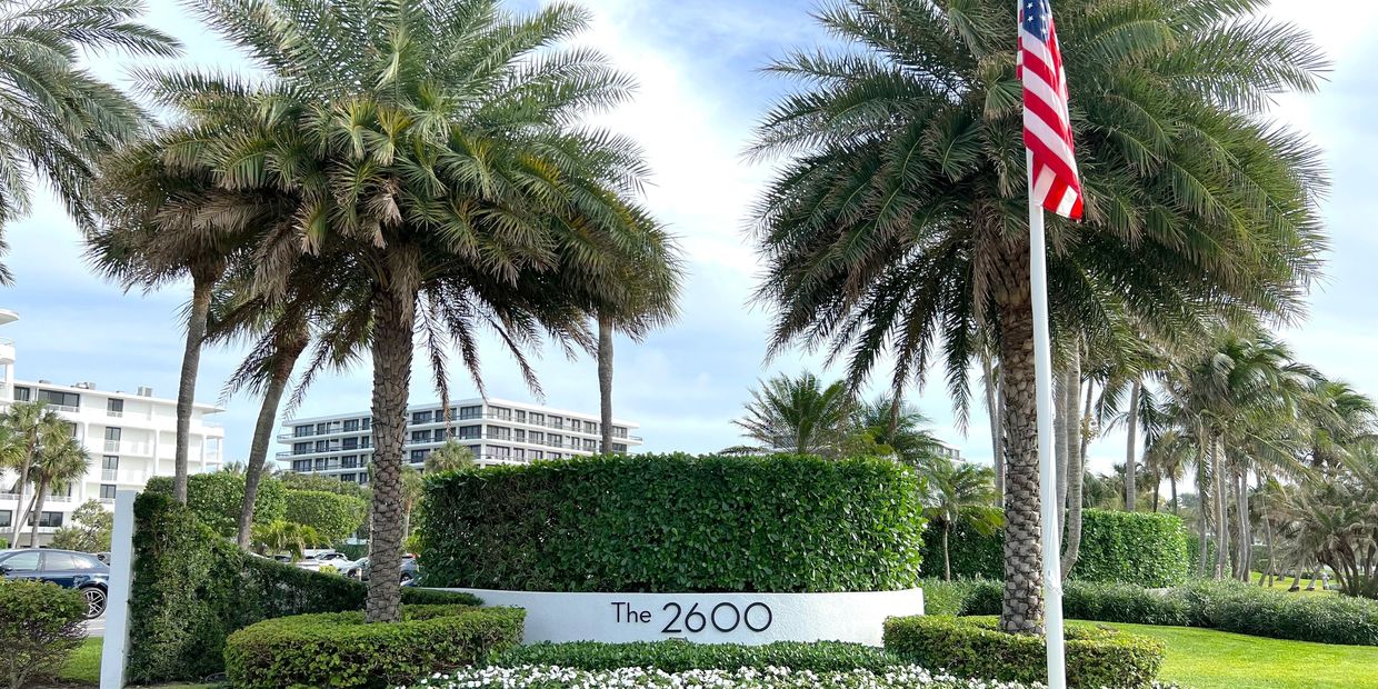 2600 Building entrance with Flag and white flowers, 2600 S Ocean Blvd., Palm Beach