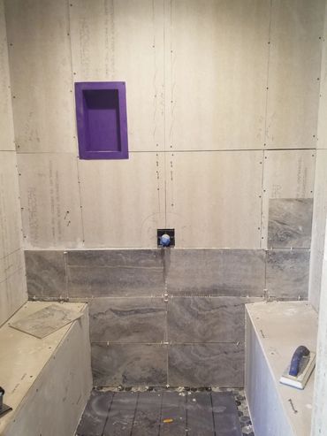 Wall Tile being put in place