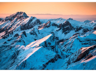 Snow-covered mountains at sunset.