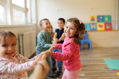 A group of children playing and smiling.