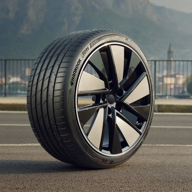Photo of a HANKOOK ioN-evo AS tire on a street with a city and mountain in background.