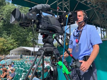 Kyle Ritchie operating video camera for SE Systems at MerleFest music festival