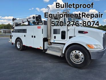 White service truck labeled with Bulletproof Equipment Repair and phone number.