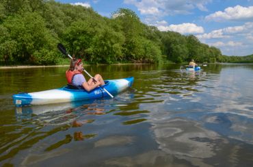 A kayaker paddling down the Grand River