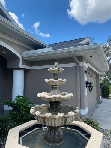 Seamless gutters and leaf guards installed on a house in woodland waters