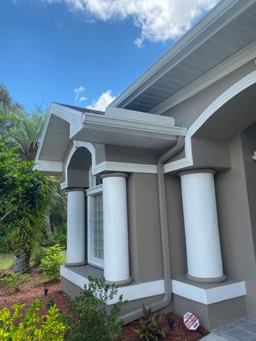 Seamless gutters installed on a house in woodland waters.