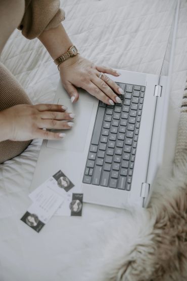 Delia Hines REALTOR® responding to clients on laptop - contact a Columbia SC real estate agent