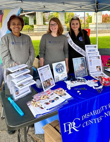 Group from Disability Rights Center - NH promoting their services at an event outdoors