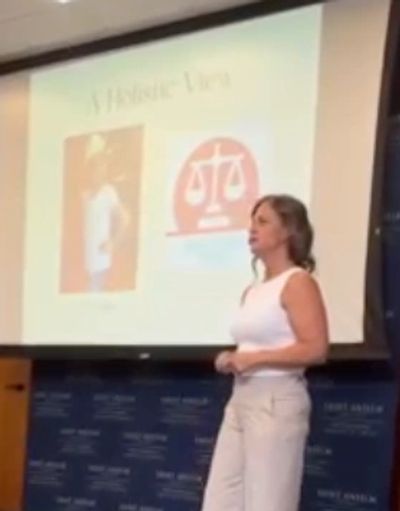 woman speaking in front of screen