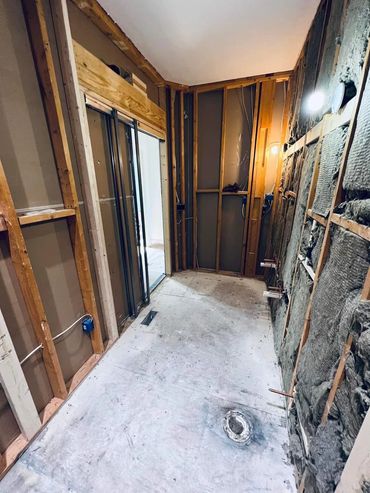 Room under renovation with exposed wooden framing and insulation.