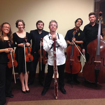 Daniel Nester holding his bassoon with members of the Kent/Blossom music festival