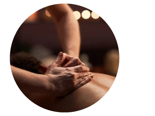 Hands giving a relaxing back massage in a warm, dimly lit setting.