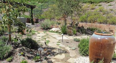 rustic vase fountain in mission style backyard