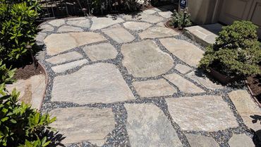 stone and pebble hardscape surrounded by landscape in Orange County
