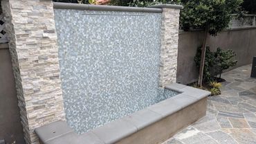 stone and tile masonry on contemporary waterfall fountain