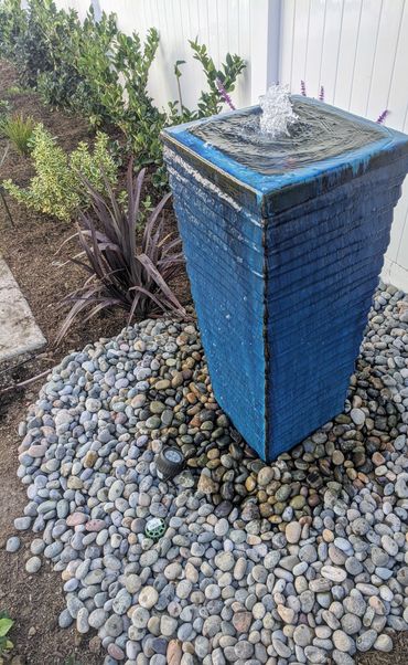Beautiful blue vase fountain adds the sound of moving water