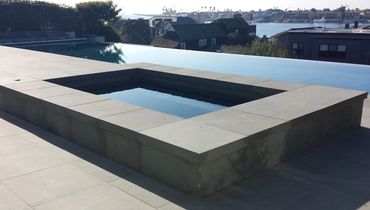 modern concrete hardscape around spa and infinity pool Newport Beach