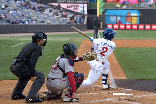 Baseball batter Culpepper swings at a pitch with catcher and umpire behind.