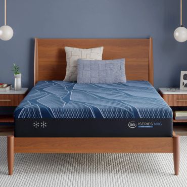 Modern bed with blue bedding and wooden frame.