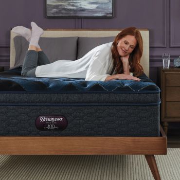 Woman lying on a Beautyrest mattress, smiling.