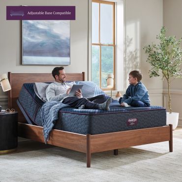 Father and son chatting on an adjustable bed.