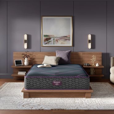Modern bedroom with a wooden bed and abstract painting.