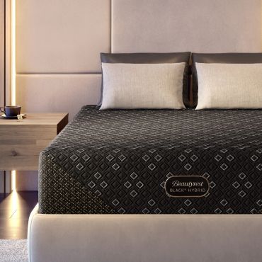 Cozy bedroom with a Beautyrest Black Hybrid mattress and beige pillows.
