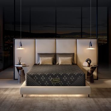 Modern bedroom with luxury mattress and city night view.