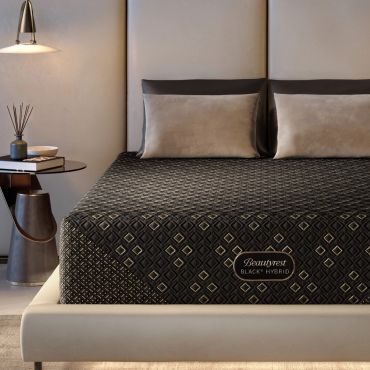 Modern bedroom with Beautyrest Black Hybrid mattress and bedside table.